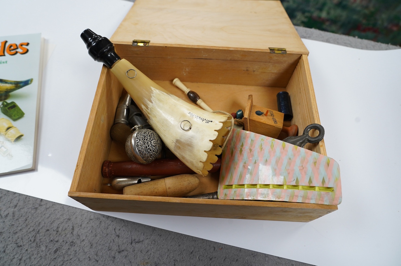 A collection of whistles including a horn example, a tin whistle, novelty bird whistles, etc. Condition - fair